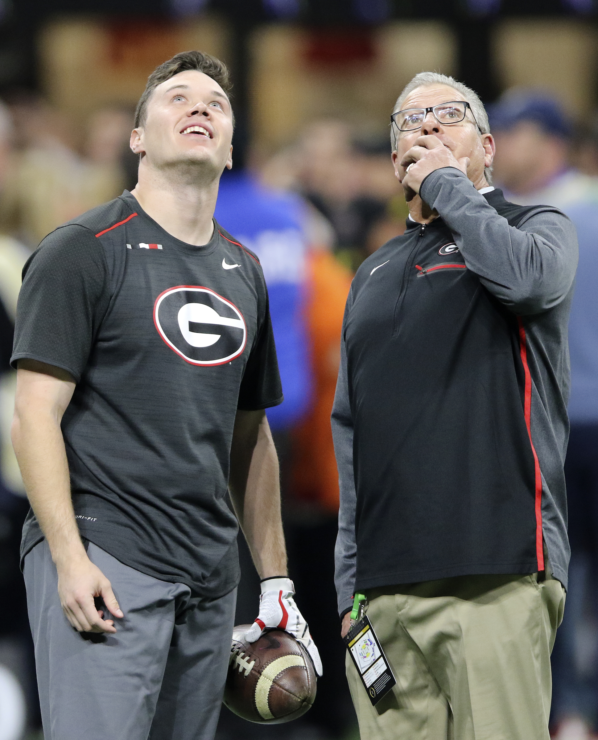 Georgia punter Cameron Nizialek, left, and student assistant Kevin Butler look towards the roof of Mercedes-Benz Stadium to see if it is leaking before the College Football Playoff national championship against Alabama at Mercedes-Benz Stadium on Monday, Jan. 8, 2018 in Atlanta, Ga.