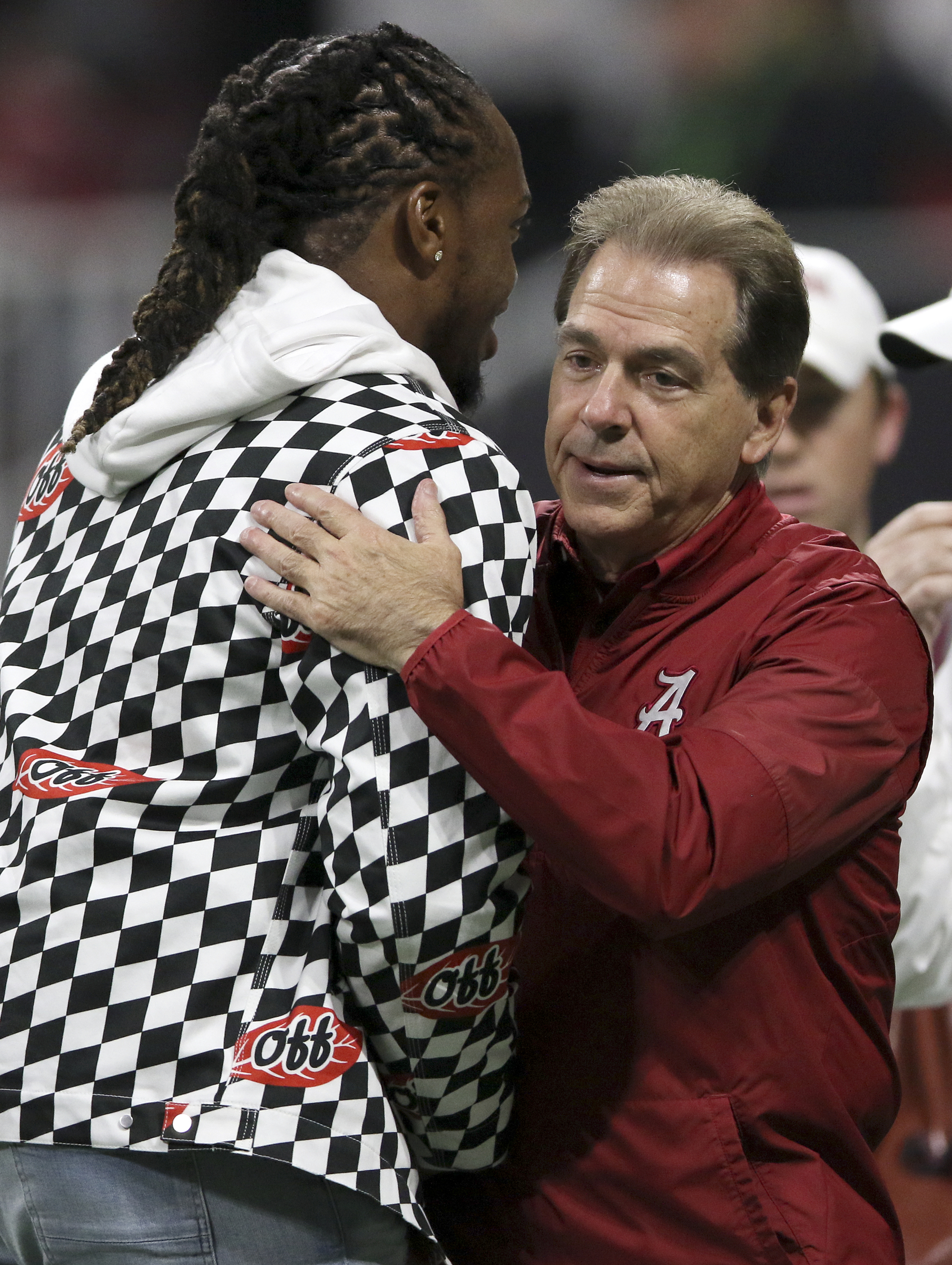 Former Alabama, and current Tennessee Titan, running back Derrick Henry, left, greats Alabama head coach Nick Saban before the College Football Playoff national championship between Alabama and Georgia at Mercedes-Benz Stadium on Monday, Jan. 8, 2018 in Atlanta, Ga.
