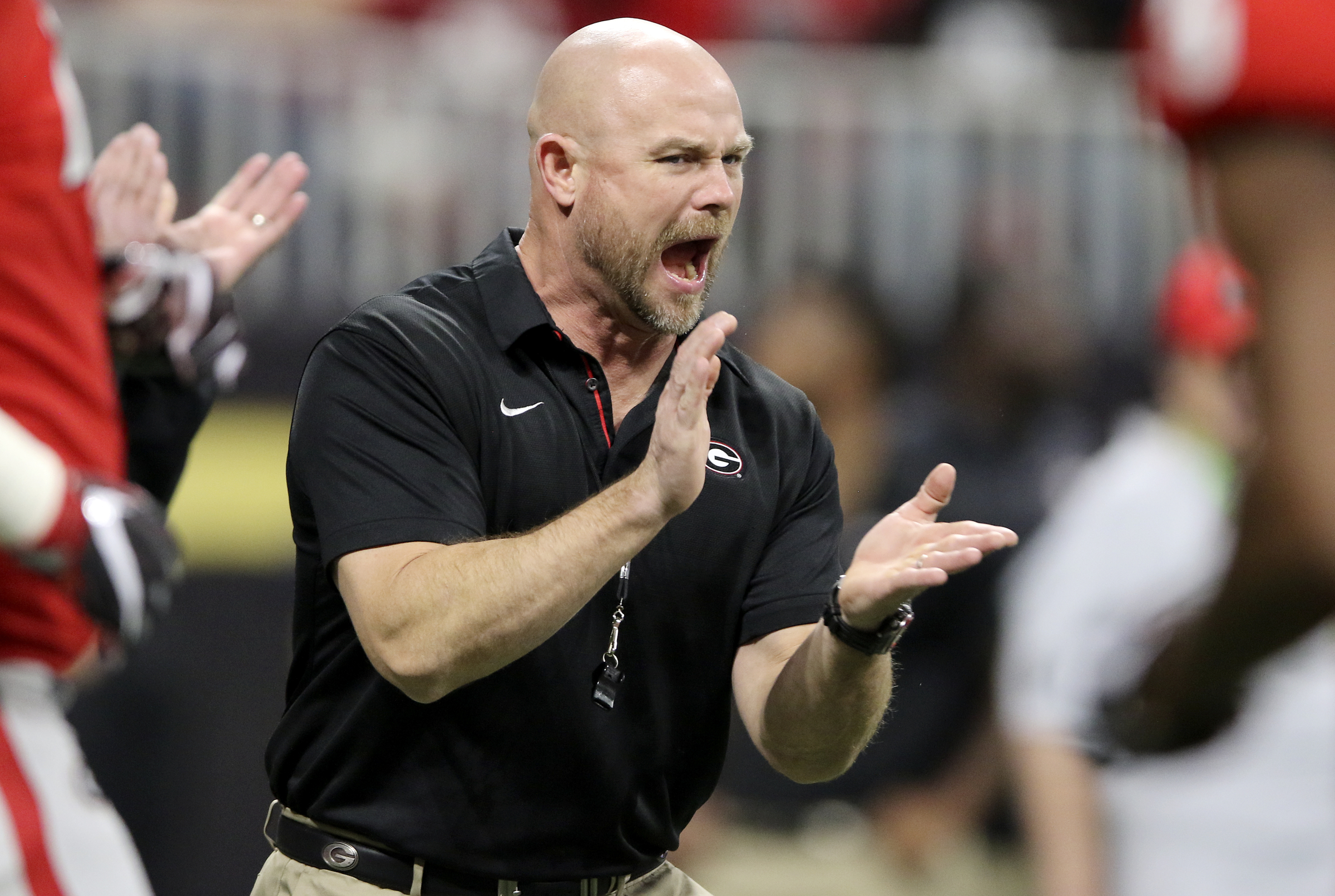 Georgia director of strength and conditioning Scott Sinclair claps as the Bulldogs warm up before the College Football Playoff national championship against Alabama at Mercedes-Benz Stadium on Monday, Jan. 8, 2018 in Atlanta, Ga.