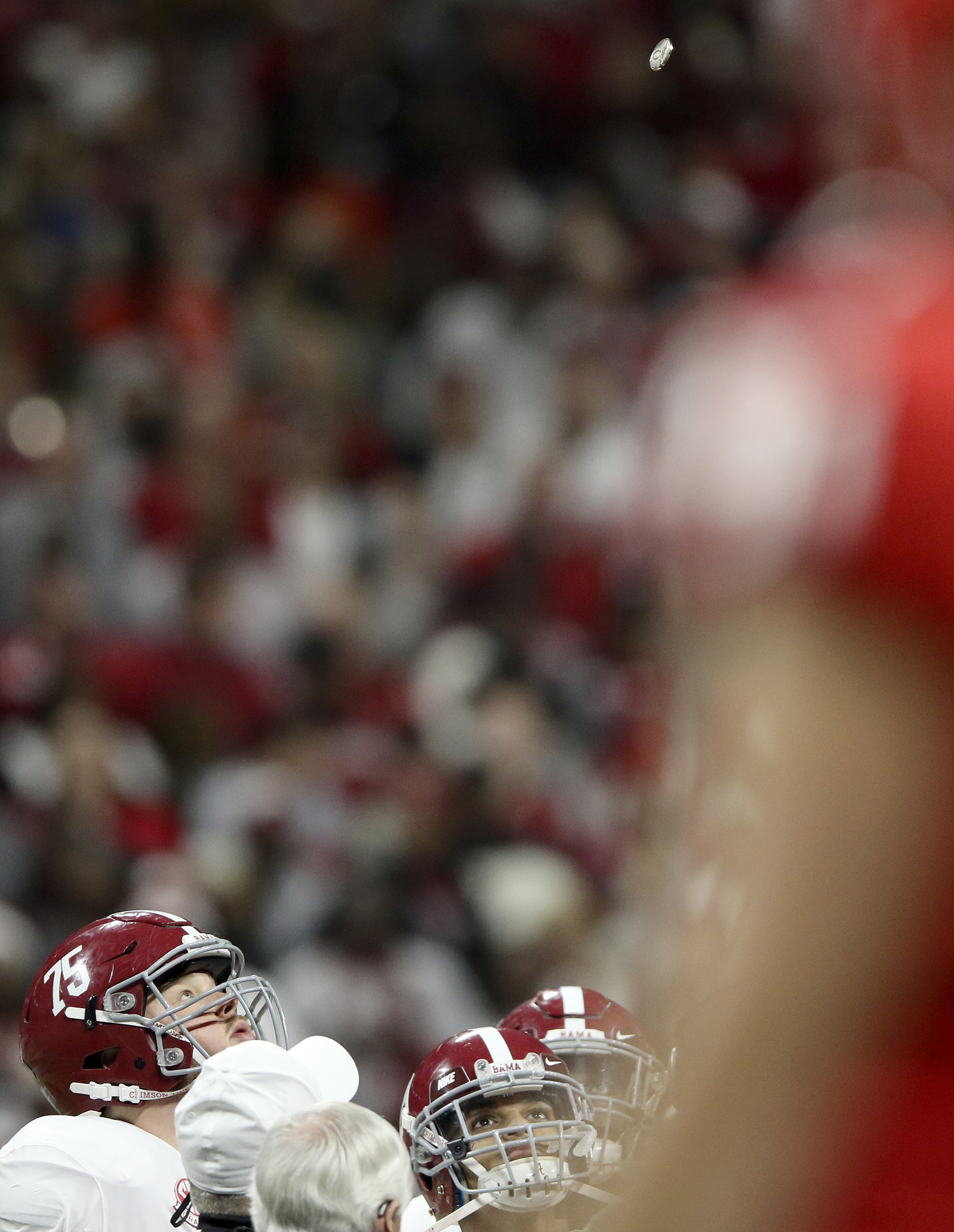 Alabama offensive lineman Bradley Bozeman (75) watches the coin as it flips through the air before the College Football Playoff national championship against Georgia at Mercedes-Benz Stadium on Monday, Jan. 8, 2018 in Atlanta, Ga.