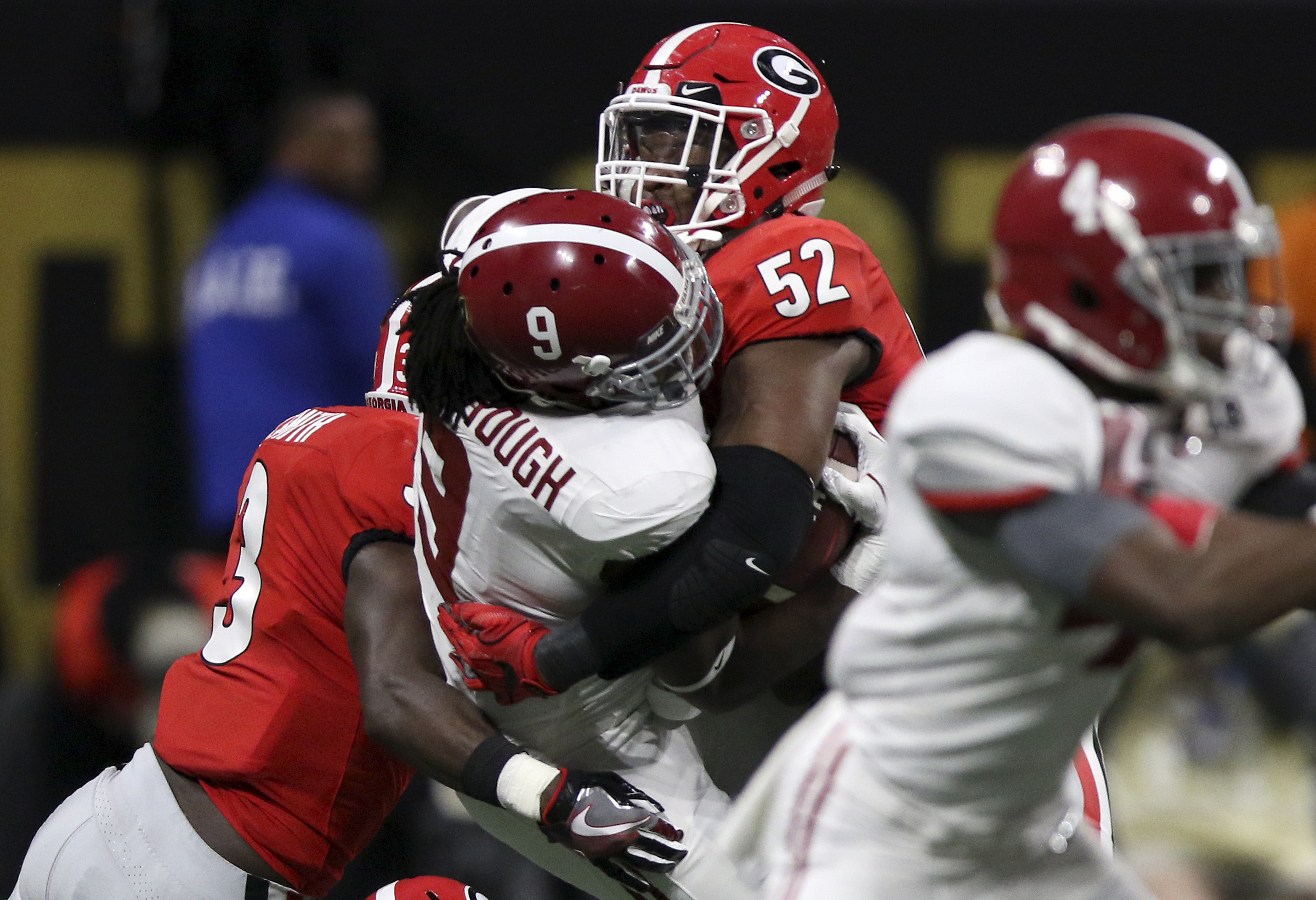 Georgia defensive lineman Tyler Clark (52) hits Alabama running back Bo Scarbrough (9) after Scarbrough gained four yards on a rush during the College Football Playoff national championship at Mercedes-Benz Stadium on Monday, Jan. 8, 2018 in Atlanta, Ga.