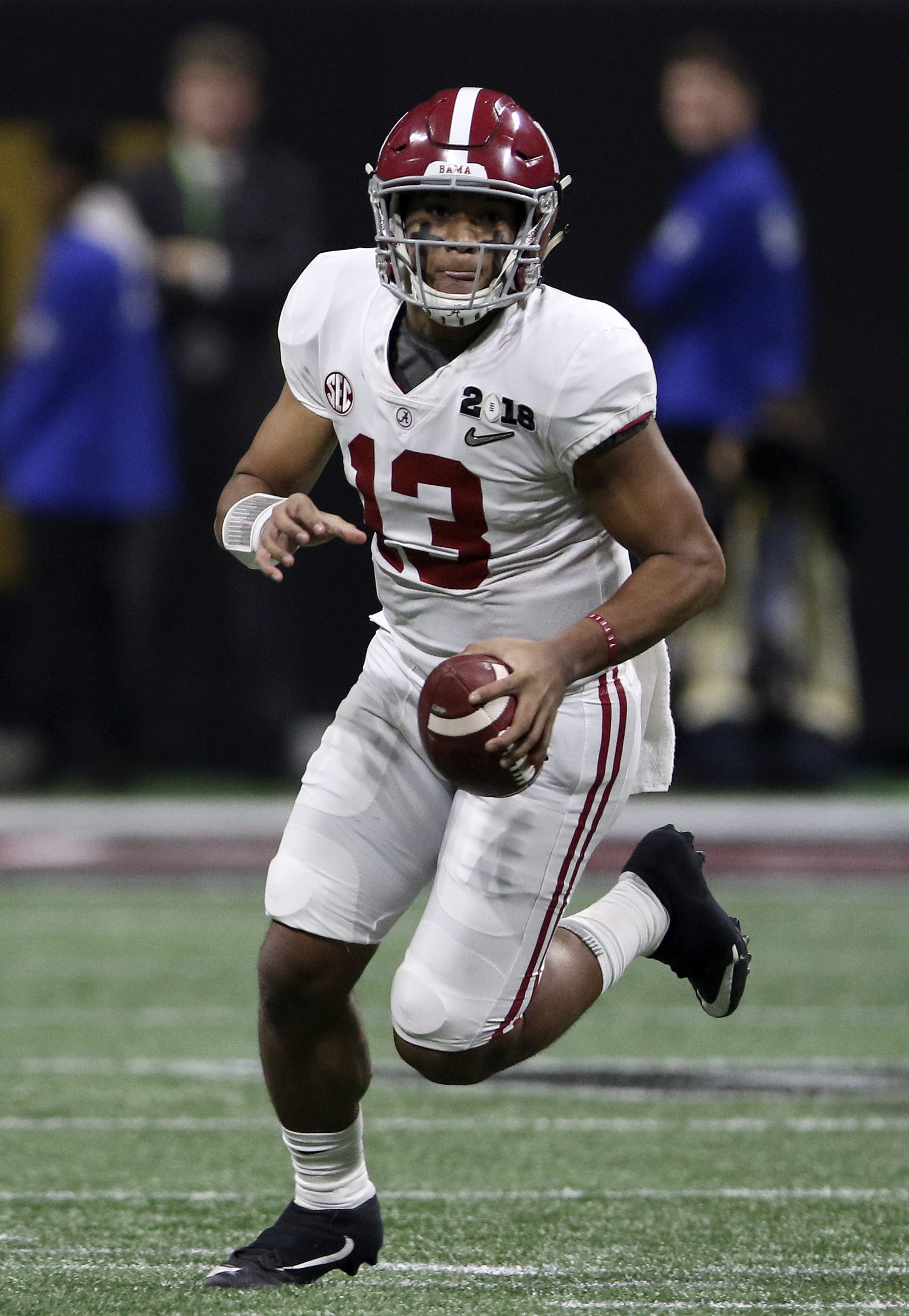 Alabama quarterback Tua Tagovailoa (13) scrambles for a 9-yard gain against Georgia during the College Football Playoff national championship at Mercedes-Benz Stadium on Monday, Jan. 8, 2018 in Atlanta, Ga.