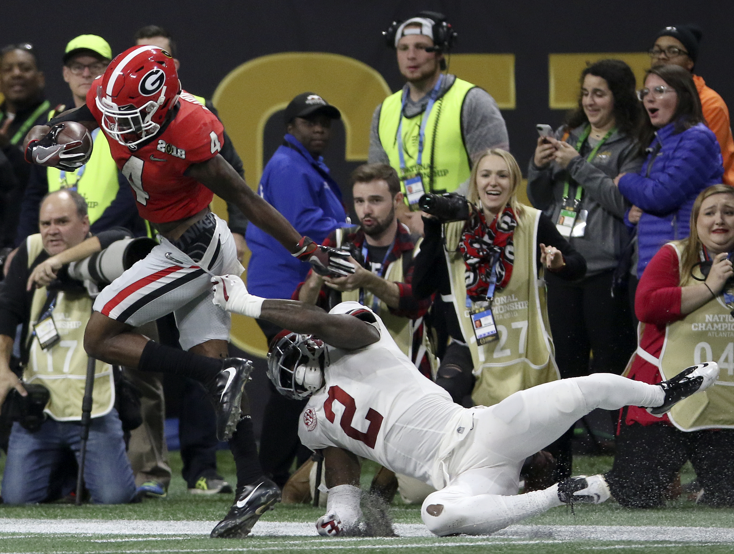 Georgia wide receiver Mecole Hardman Jr. (4) stays inbounds as he breaks away from Alabama defensive back Tony Brown (2) for an 80-yard touchdown reception during the College Football Playoff national championship at Mercedes-Benz Stadium on Monday, Jan. 8, 2018 in Atlanta, Ga.
