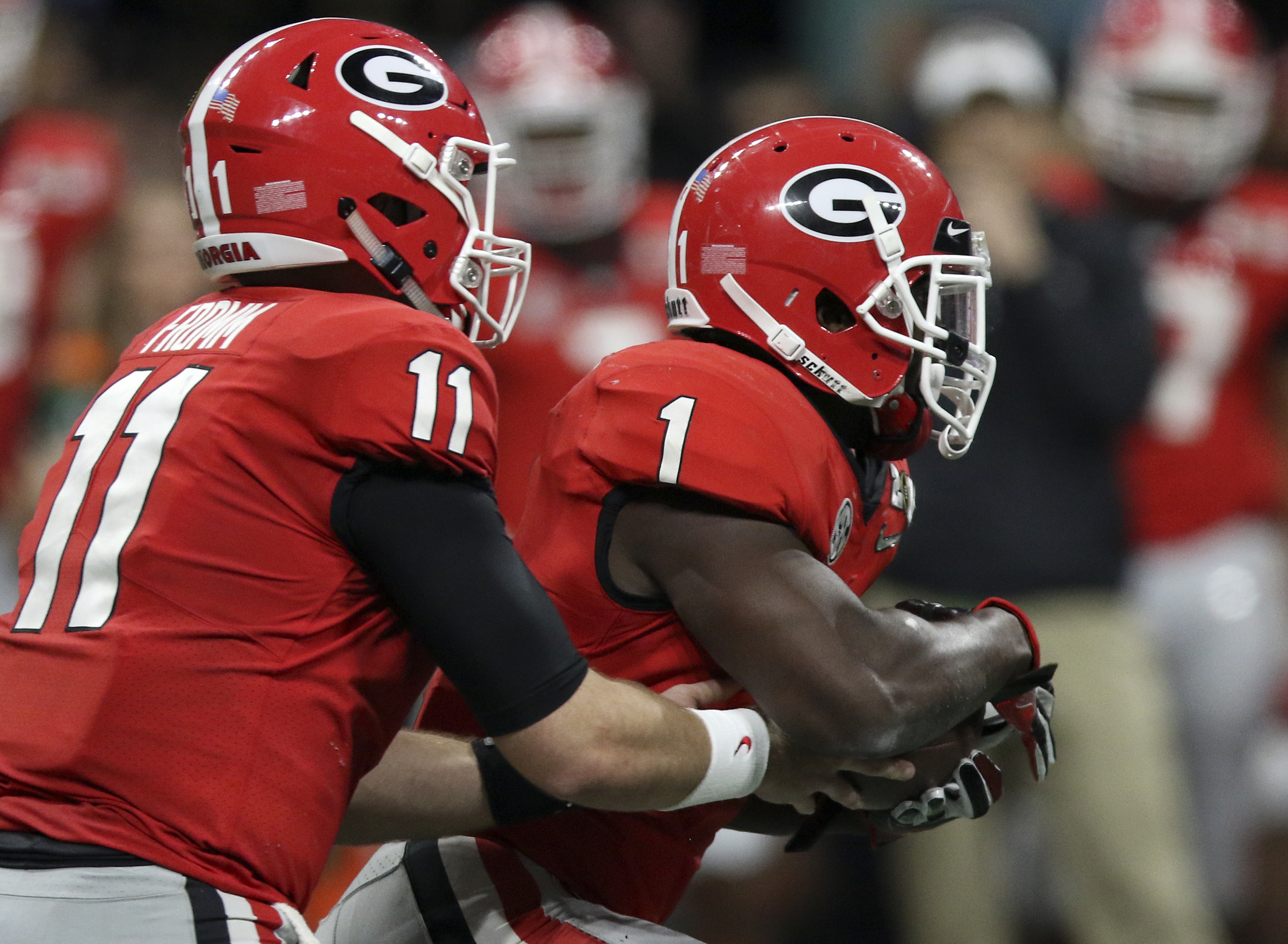 Georgia quarterback Jake Fromm (11) hands the ball off to running back Sony Michel (1) during the College Football Playoff national championship against Alabama at Mercedes-Benz Stadium on Monday, Jan. 8, 2018 in Atlanta, Ga.