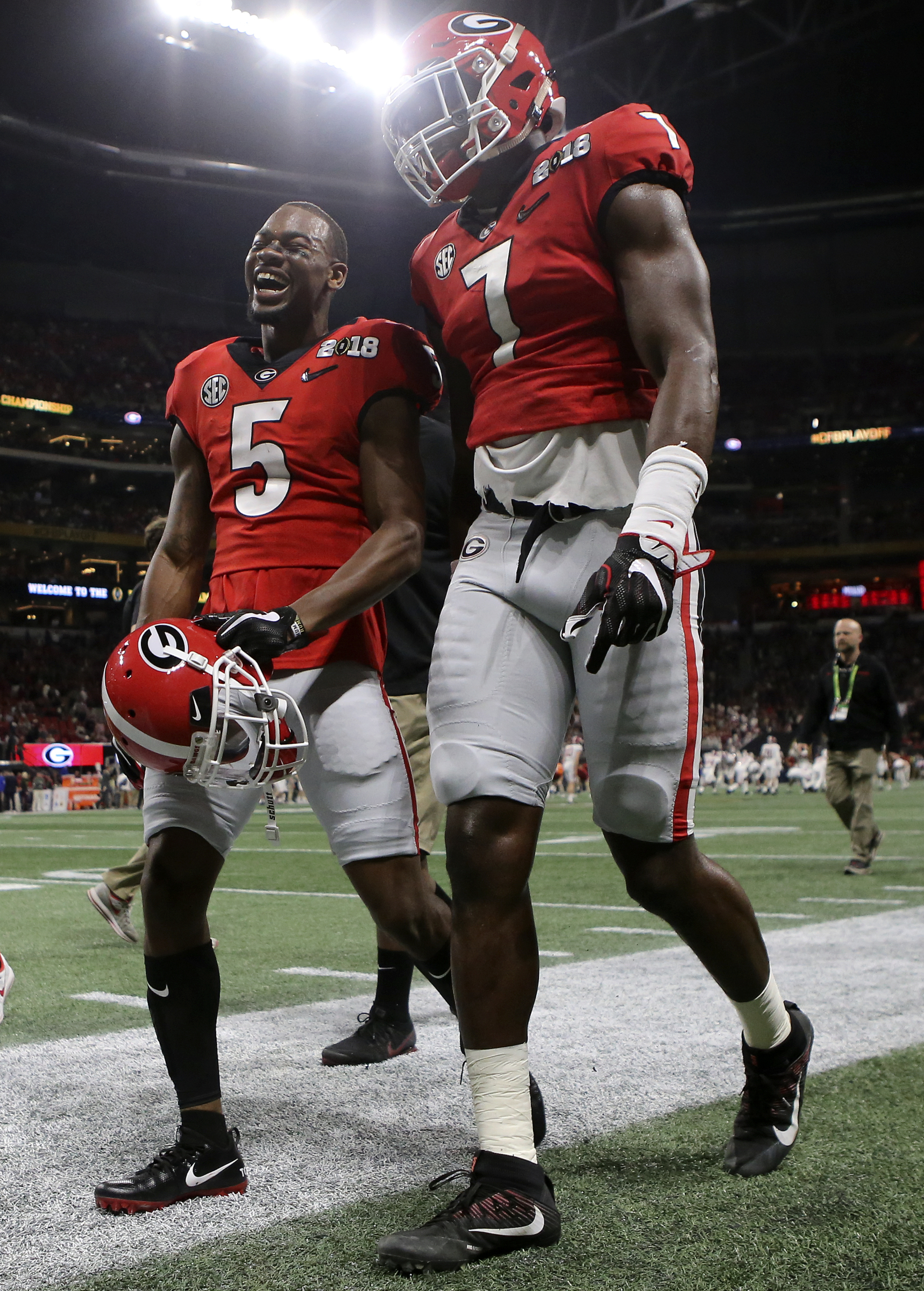 Georgia wide receiver Terry Godwin (5) and linebacker Lorenzo Carter (7) share a laugh as they head into the locker room after warming up before the College Football Playoff national championship against Alabama at Mercedes-Benz Stadium on Monday, Jan. 8, 2018 in Atlanta, Ga.