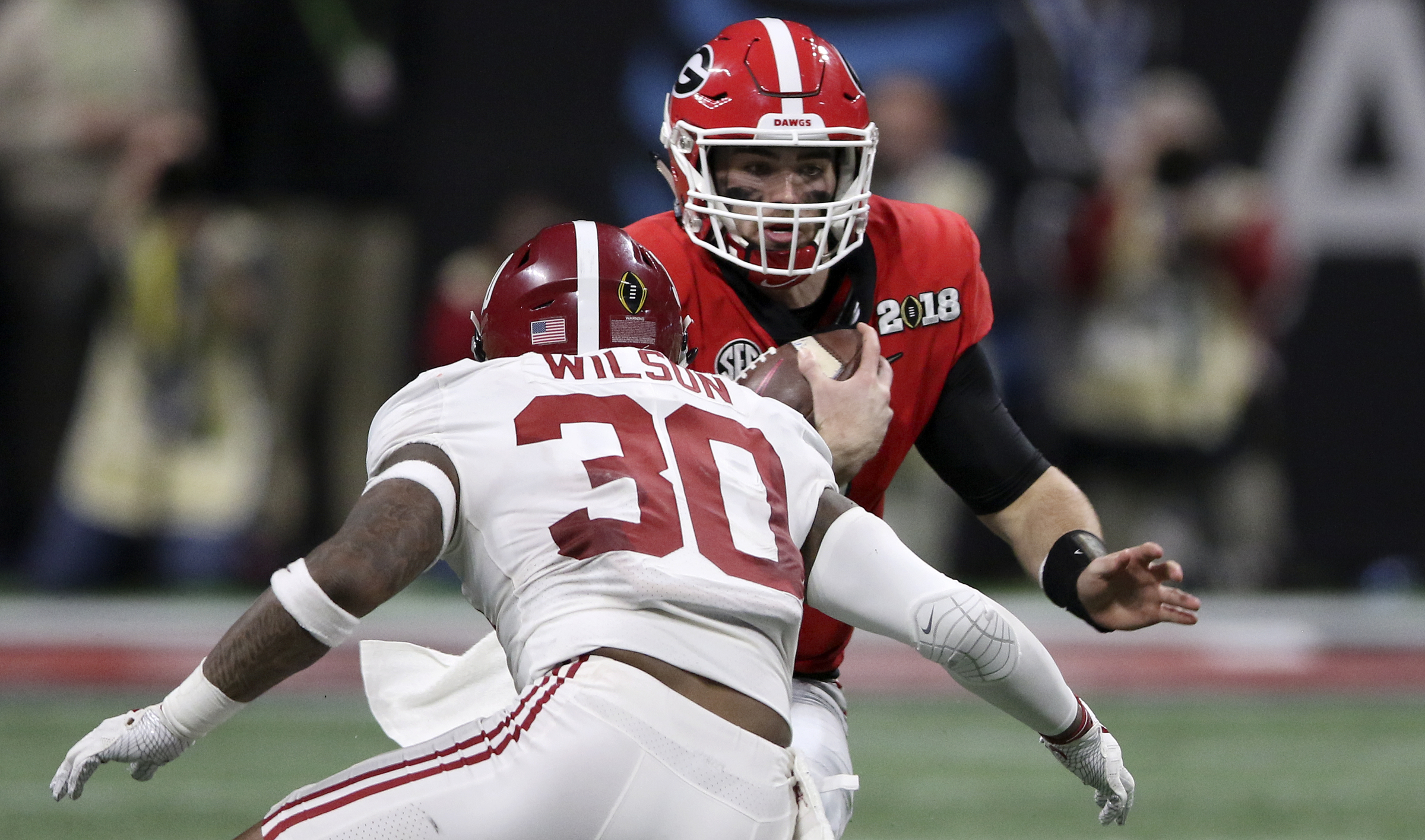 Georgia quarterback Jake Fromm (11) evades Alabama linebacker Mack Wilson (30) on a 5-yard rush during the College Football Playoff national championship at Mercedes-Benz Stadium on Monday, Jan. 8, 2018 in Atlanta, Ga.