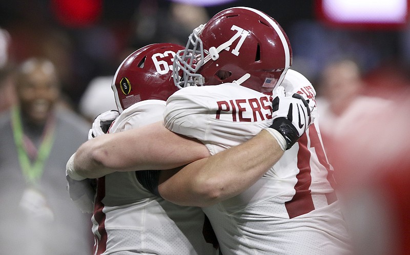 Alabama offensive linemen J.C. Hassenauer (63) and Ross Pierschbacher (71) celebrate their College Football Playoff national championship overtime victory over Georgia at Mercedes-Benz Stadium on Monday, Jan. 8, 2018 in Atlanta, Ga.