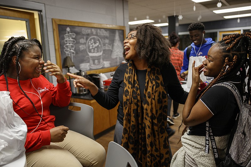 Stephanie Hayes, center, jokes with students Rayne Heathington, left, and Serenity Smith during the LEOS after-school program at the Red Bank Community School at Red Bank High School on Tuesday, Jan. 9, 2018, in Chattanooga, Tenn. The community school is a resource for both community members and students by offering services such as after-school programs and HiSET exam assistance. It celebrated its one-year anniversary Tuesday.