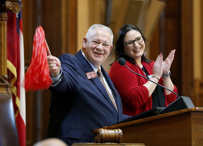 House Speaker David Ralston waves a pom pom in honor of Georgia's appearance in the NCAA college football championship game tonight against Alabama as the legislative session adjourns on its first day in Atlanta, Monday, Jan. 8, 2018. (AP Photo/David Goldman)