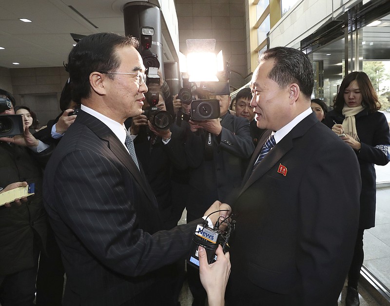 South Korean Unification Minister Cho Myoung-gyon, left, shakes hands with the head of North Korean delegation Ri Son Gwon before their meeting at the Panmunjom in the Demilitarized Zone in Paju, South Korea, Tuesday, Jan. 9, 2018. South Korean media said North and South Korea have begun talks at their border about how to cooperate in next month's Winter Olympics and how to improve their long-strained ties. (Korea Pool/Yonhap via AP)