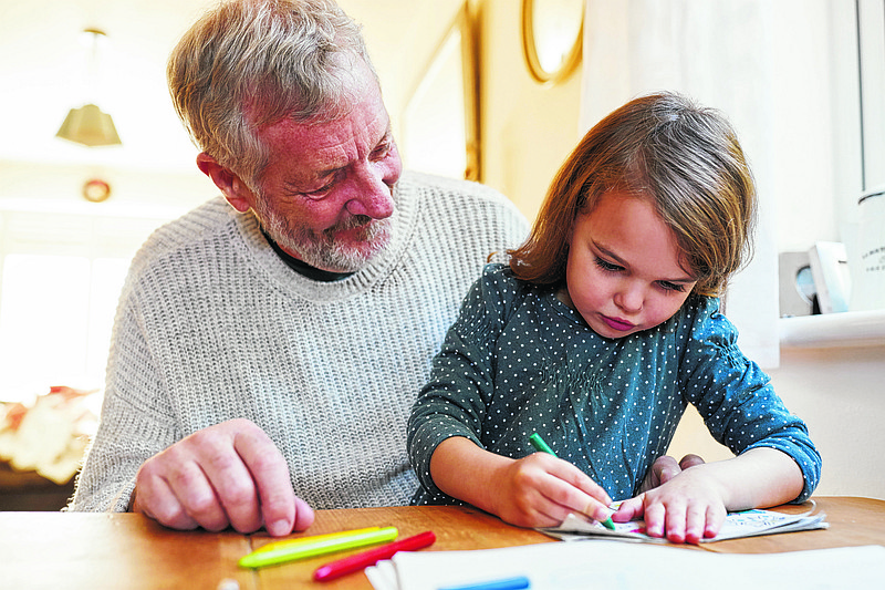 Grandfather And Granddaughter Colouring Picture Together