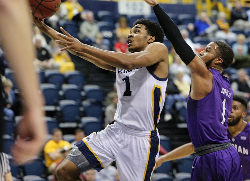University of Tennessee at Chattanooga guard Rodney Chatman (1) puts up a shot while being guarded by Furman University's John Davis III (1) during UTC's game against Furman Wednesday, Jan. 10, 2018 at Mckenzie Arena in Chattanooga, Tenn.