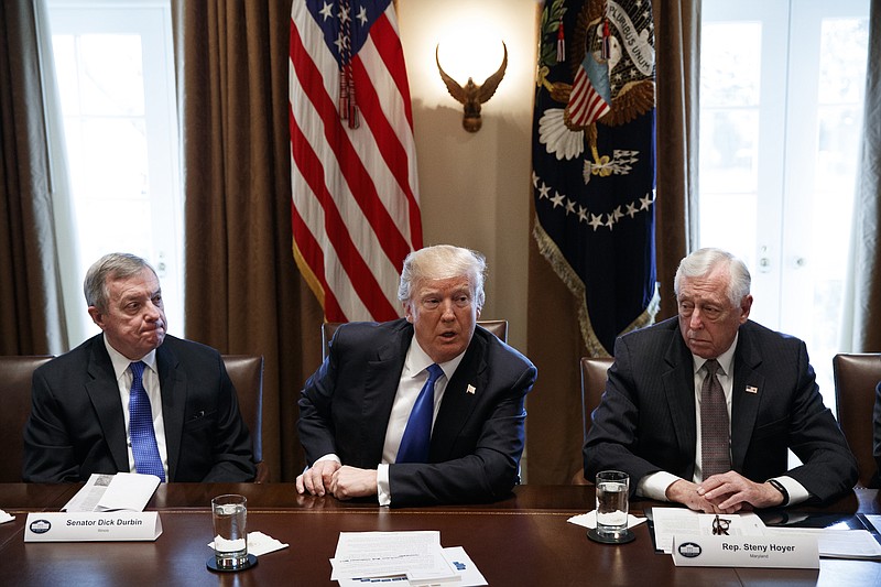 In this Jan. 9, 2017, photo, Sen. Dick Durbin, D-Ill., left, and Rep. Steny Hoyer, D-Md. listen as President Donald Trump speaks during a meeting with lawmakers on immigration policy in the Cabinet Room of the White House in Washington. Bargainers seeking a bipartisan immigration accord planned talks as soon as Wednesday as President Donald Trump and leading lawmakers sought to parlay an extraordinary White House meeting into momentum for resolving a politically blistering issue.(AP Photo/Evan Vucci)