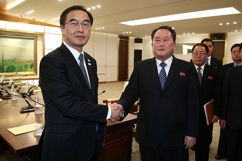 South Korean Unification Minister Cho Myoung-gyon, left, shakes hands with the head of North Korean delegation Ri Son Gwon after their meeting at the Panmunjom in the Demilitarized Zone in Paju, South Korea, Tuesday, Jan. 9, 2018. The rival Koreas took steps toward reducing their bitter animosity during rare talks Tuesday, as North Korea agreed to send a delegation to next month's Winter Olympics in South Korea and reopen a military hotline. (Korea Pool via AP)