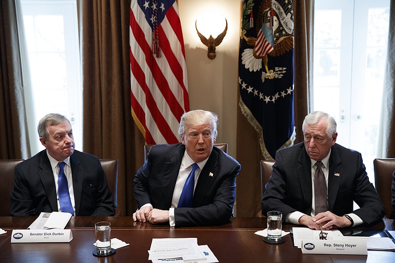 In this Jan. 9, 2017, photo, Sen. Dick Durbin, D-Ill., left, and Rep. Steny Hoyer, D-Md. listen as President Donald Trump speaks during a meeting with lawmakers on immigration policy in the Cabinet Room of the White House in Washington.