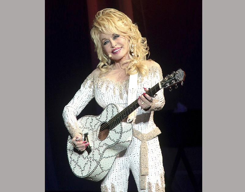 FILE - In this June 15, 2016 file photo, Dolly Parton performs in concert during her Pure & Simple Tour in Philadelphia.