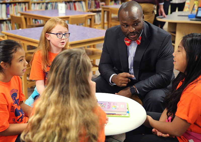 Dr. Bryan Johnson, superintendent of Hamilton County Schools, speaks to fifth graders Samantha Johnson, Aida Bautista, Cate Barton and Shadi Gonzalez about the new additions to their library at East Ridge Elementary School. More than 14 percent of East Ridge Elementary students are English language learners, and their school is a feeder school to East Ridge Middle School, recognized as a "reward" school for student growth.