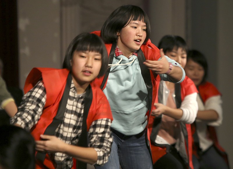 Tono, Japan, exchange student Momoka Tanifuji, center, performs with fellow exchange students during a celebration between sister cities Chattanooga and Tono in the Creed Bates Memorial Auditorium at Chattanooga School for the Arts and Sciences on Thursday, Jan. 11, 2018 in Chattanooga, Tenn. Students from CSAS have been participating in an exchange with Tono since 1991 helping establish a sister city partnership with Chattanooga.