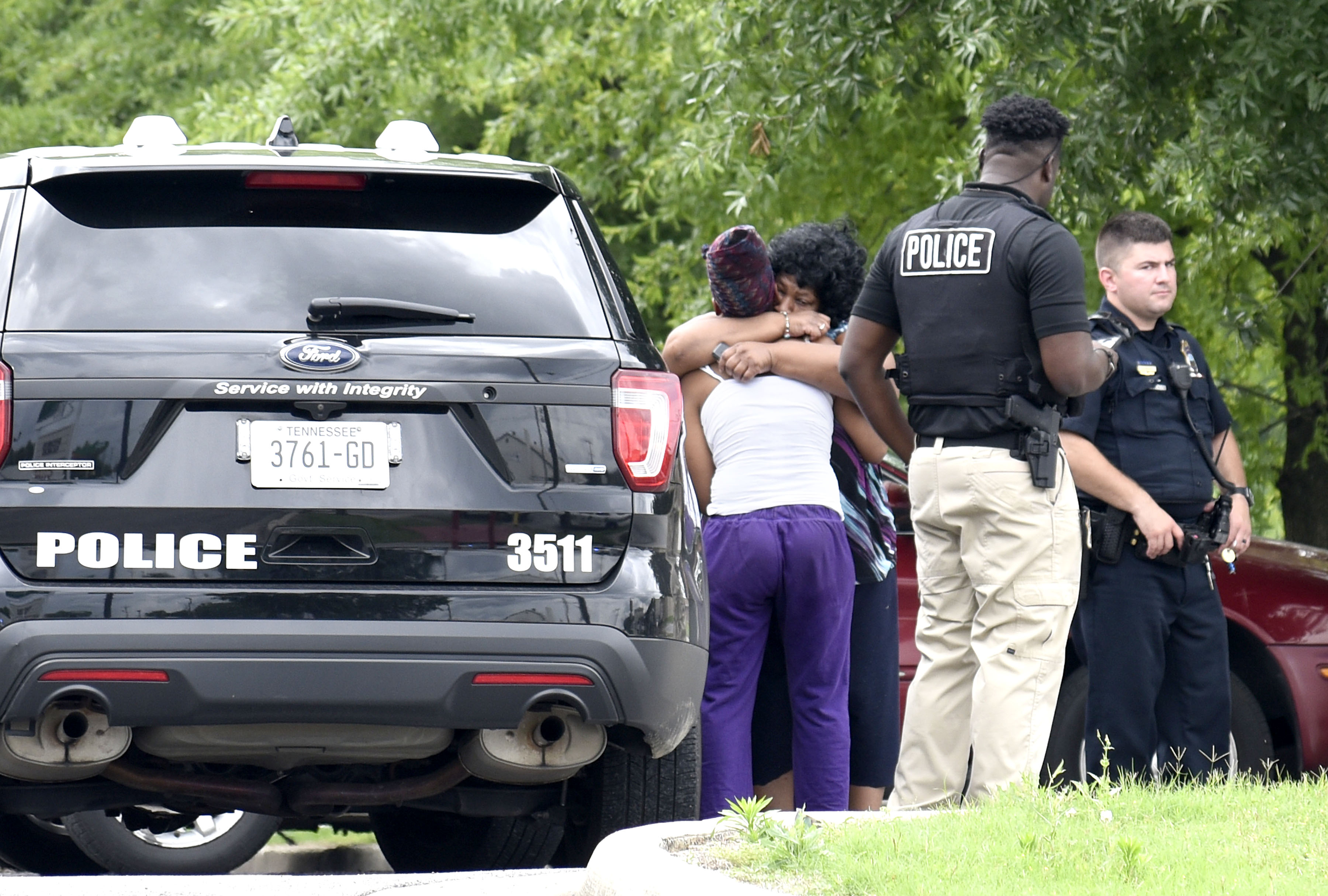 Two women comfort each other while Chattanooga Police investigate the scene of a shooting at the Hamilton Inn at 2717 Rossville Blvd on July 2, 2017.