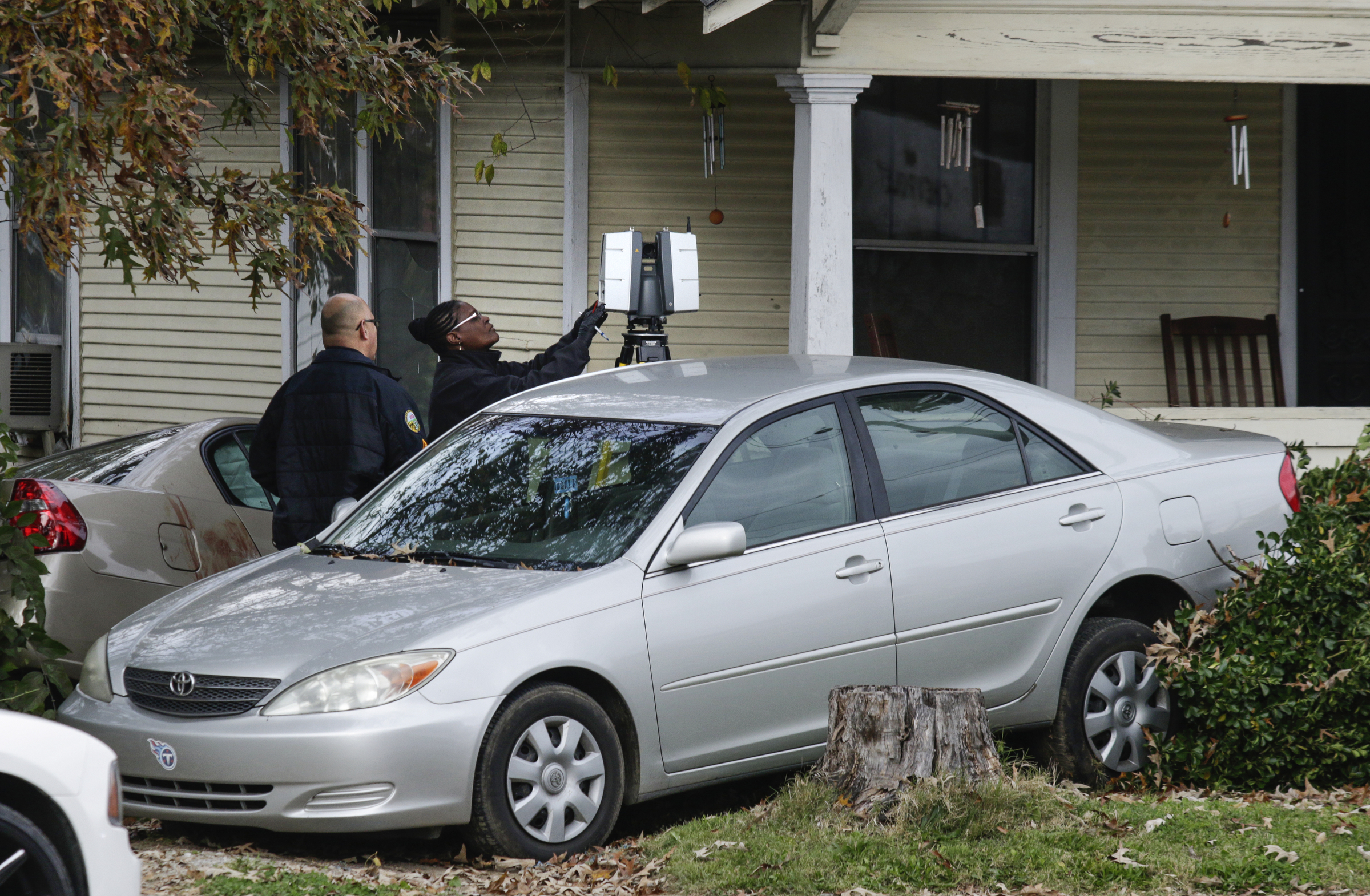 Blood is visible on one of two vehicles crashed into the yard of a home at 1403 Roanoke Avenue as Chattanooga police investigate the scene of a morning shooting on Saturday, Nov. 18, 2017, in Chattanooga, Tenn.
