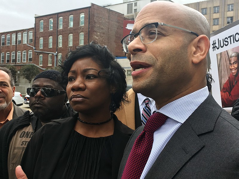 Monteria Robinson, mother of Jamarion Robinson, who was schizophrenic and shot by police in August 2016, stands with her lawyer, Andrew M. Stroth, as he addresses reporters at a news conference outside the federal courthouse, Wednesday, Jan. 10, 2018, in Atlanta. A federal civil rights lawsuit alleges law enforcement officers used excessive force and then tried to cover their actions in the fatal shooting of Jamarion Robinson. (AP Photo/Kate Brumback)