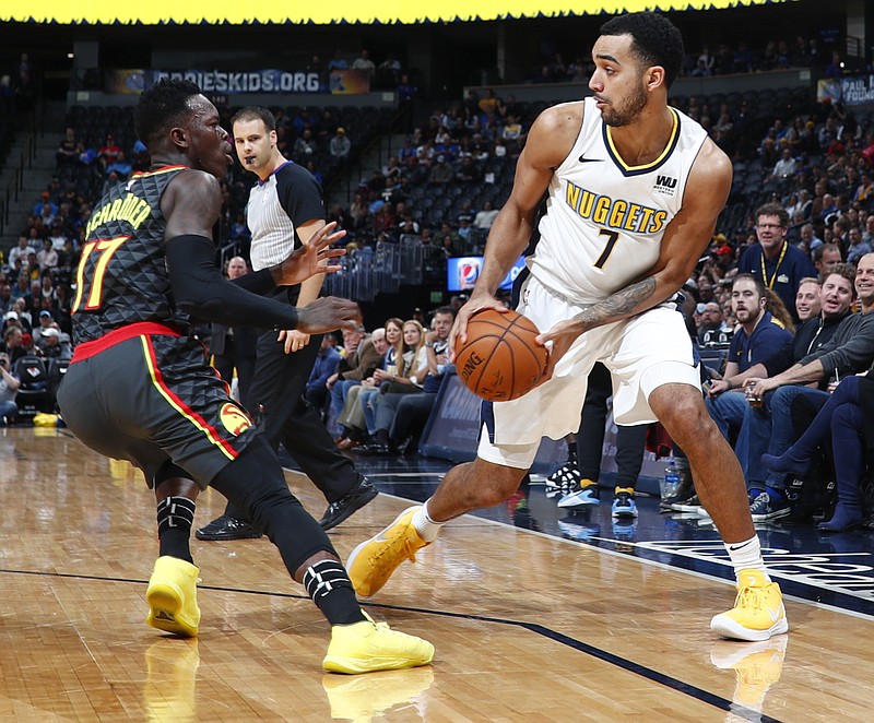 Denver Nuggets forward Trey Lyles, right, looks to pass the ball as Atlanta Hawks guard Dennis Schroder, of Germany, defends in the first half of an NBA basketball game Wednesday, Jan. 10, 2018 in Denver. (AP Photo/David Zalubowski)