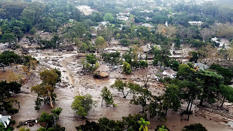 This aerial photo provided by the Santa Barbara County Fire Department shows mudflow and damage to homes in Montecito, Calif., Wednesday, Jan. 10, 2018. Anxious family members awaited word on loved ones Wednesday as rescue crews searched grimy debris and ruins for more than a dozen people missing after mudslides in Southern California on Tuesday destroyed over a 100 houses, swept cars to the beach and left more than a dozen victims dead. (Matt Udkow/Santa Barbara County Fire Department via AP)