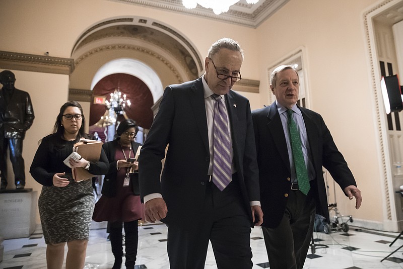 Senate Minority Leader Chuck Schumer, D-N.Y., left, walks with Sen. Dick Durbin, D-Ill., the minority whip, as lawmakers continue negotiating on a deal that would include a fix for the Deferred Action for Childhood Arrivals (DACA) program, at the Capitol in Washington, Thursday, Jan. 11, 2018. (AP Photo/J. Scott Applewhite)