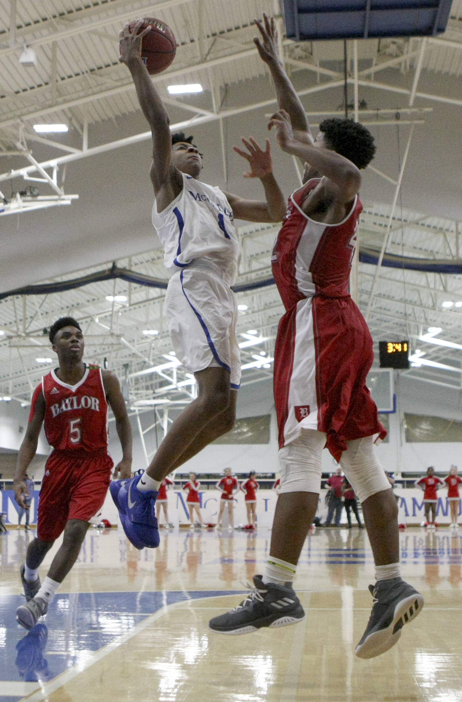 McCallie's Junior Clay (4) puts up a shot against Baylor's Niko Simpkins (42) at the Walker Forum on the campus of McCallie School on Friday, Jan. 12, 2018 in Chattanooga, Tenn.