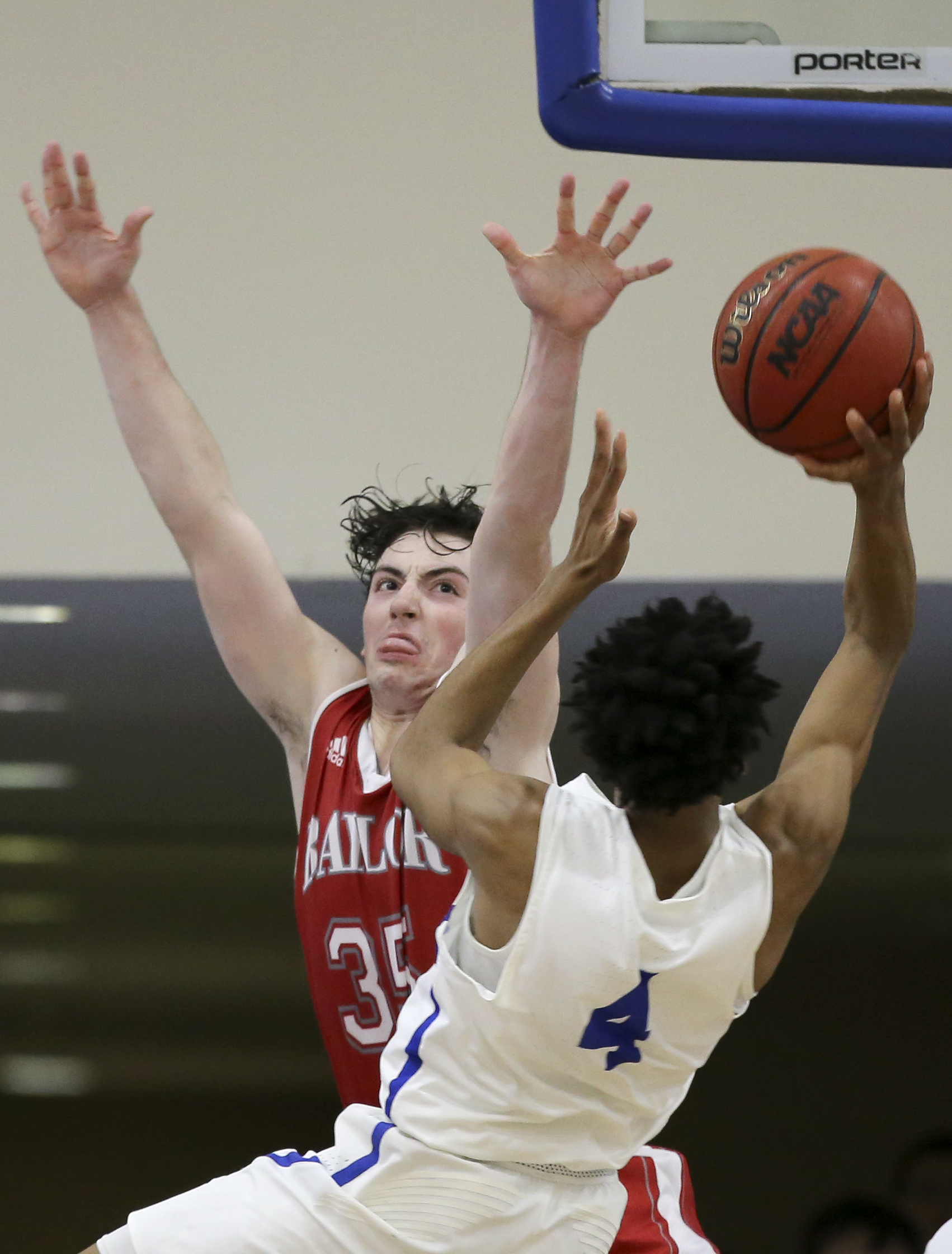 Baylor's Patrick Urey defends against McCallie's Jr. Clay (4) at the Walker Forum on the campus of McCallie School on Friday night. The Red Raiders upset their No. 1-ranked hosts 54-51.