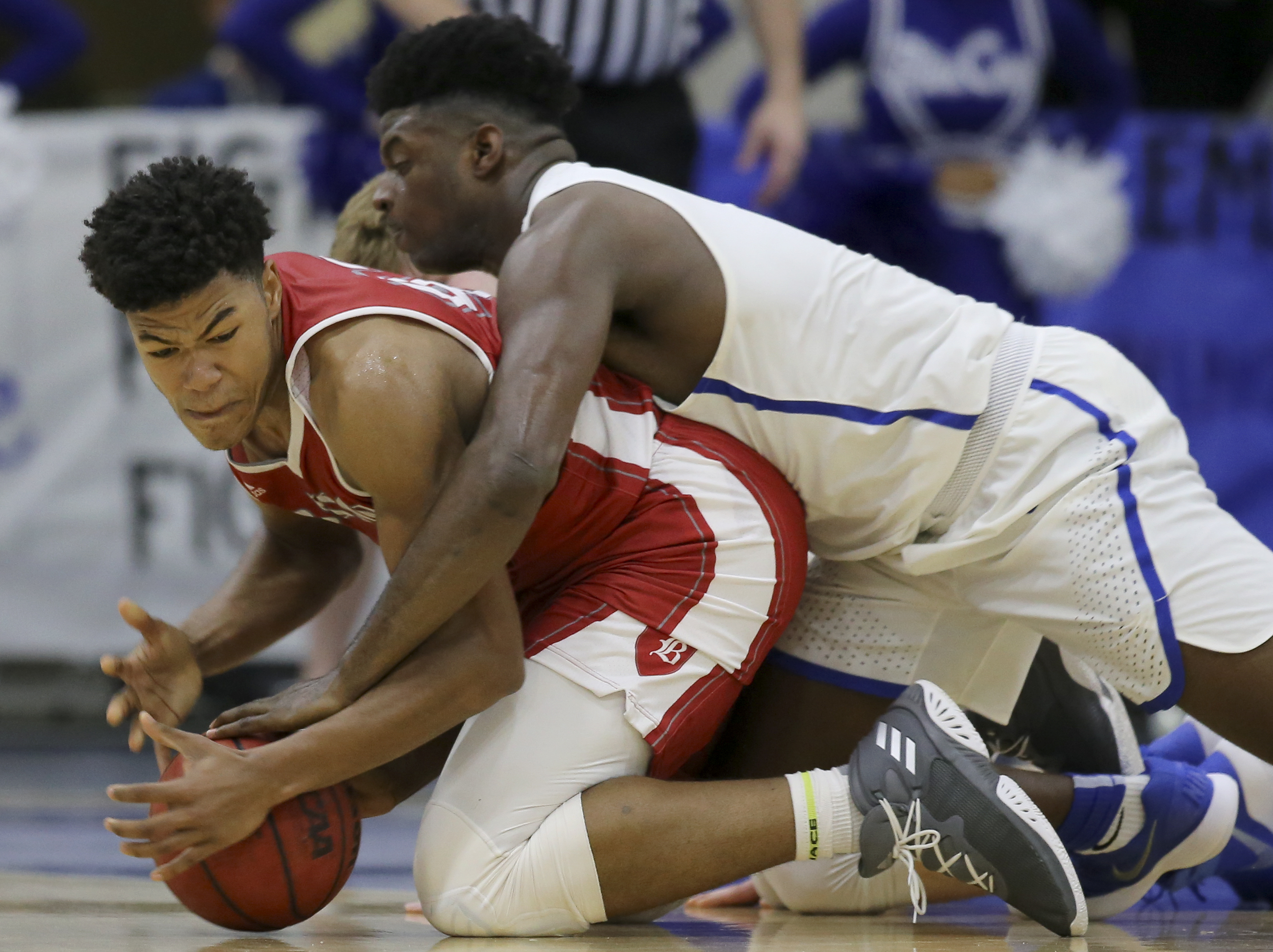 McCallie's Jorden Starling (0) and Baylor's Niko Simpkins (42) fight for the ball at the Walker Forum on the campus of McCallie School on Friday, Jan. 12, 2018 in Chattanooga, Tenn.