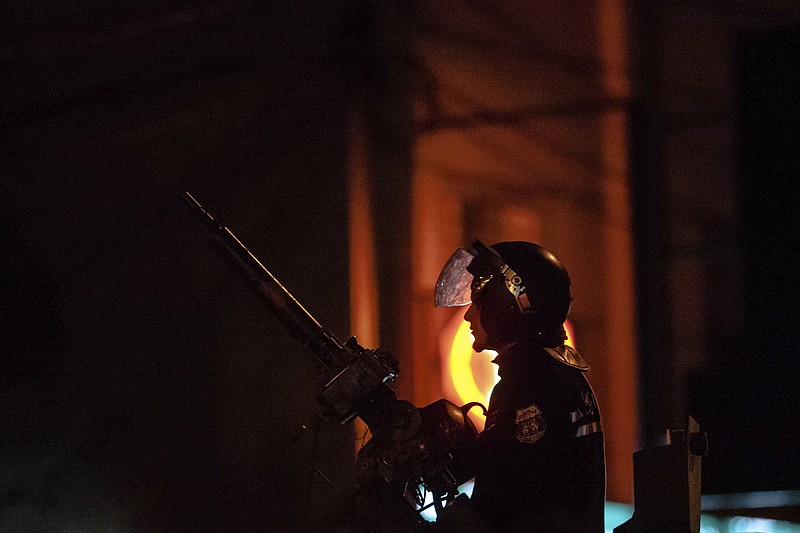 
              Riot police patrols the district of Intilaka, north of Tunis, Tunisia, Thursday Jan. 11, 2018. Tunisian authorities say 237 people were arrested and dozens of others injured across the country in recent days as violent protests against government-imposed price hikes spread to more cities and regions. (AP Photo/Amine Landoulsi)
            