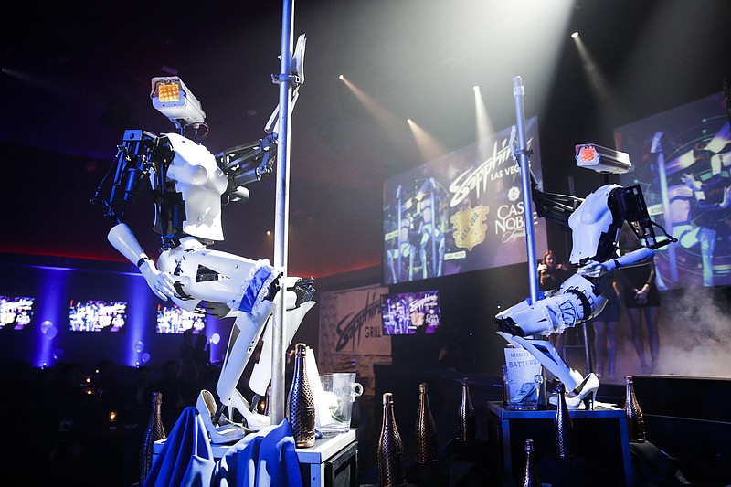 Two pole-dancing robots built by British artist Giles Walker perform at a gentlemen's club Monday, Jan. 8, 2018, in Las Vegas. The event was held to coincide with CES International. (AP Photo/Jae C. Hong)