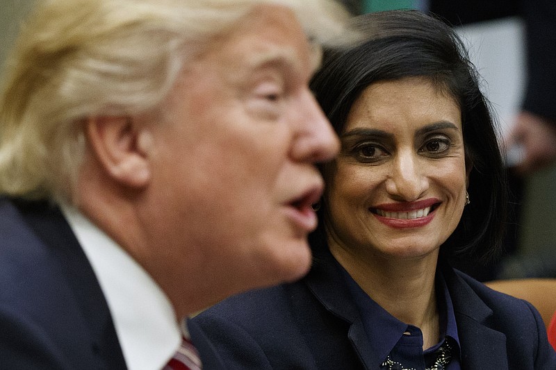 In this March 22, 2017 file photo, Administrator of the Centers for Medicare and Medicaid Services Seema Verma listen at right as President Donald Trump speaks during a meeting in the Roosevelt Room of the White House in Washington. The Trump administration says it's offering a path for states that want to seek work requirements for Medicaid recipients, and that's a major policy shift toward low-income people. (AP Photo/Evan Vucci, File)