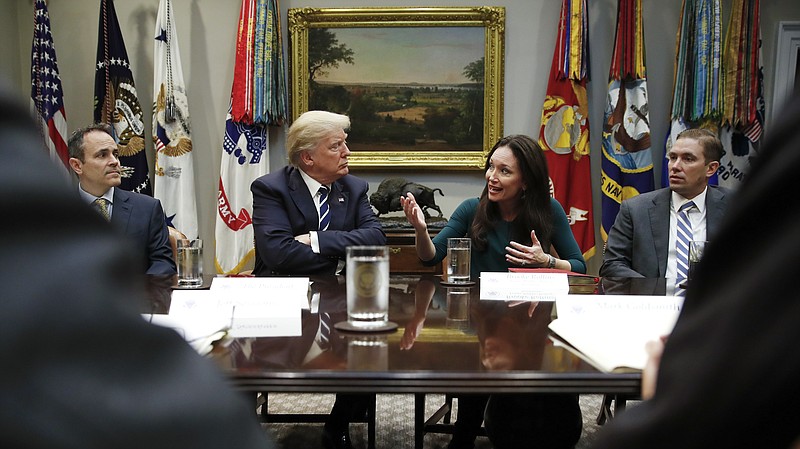 President Donald Trump, looks to Brooke Rollins, President and CEO of the Texas Public Policy Foundation, as she speaks during a prison reform roundtable in the Roosevelt Room of the Washington, Thursday, Jan. 11, 2018. (AP Photo/Carolyn Kaster)