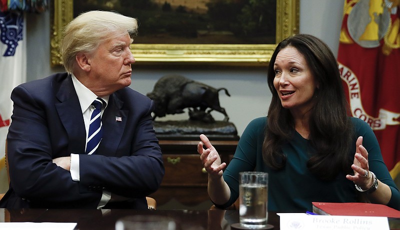 President Donald Trump, looks to Brooke Rollins, President and CEO of the Texas Public Policy Foundation, as she speaks during a prison reform roundtable in the Roosevelt Room of the Washington, Thursday, Jan. 11, 2018. (AP Photo/Carolyn Kaster)