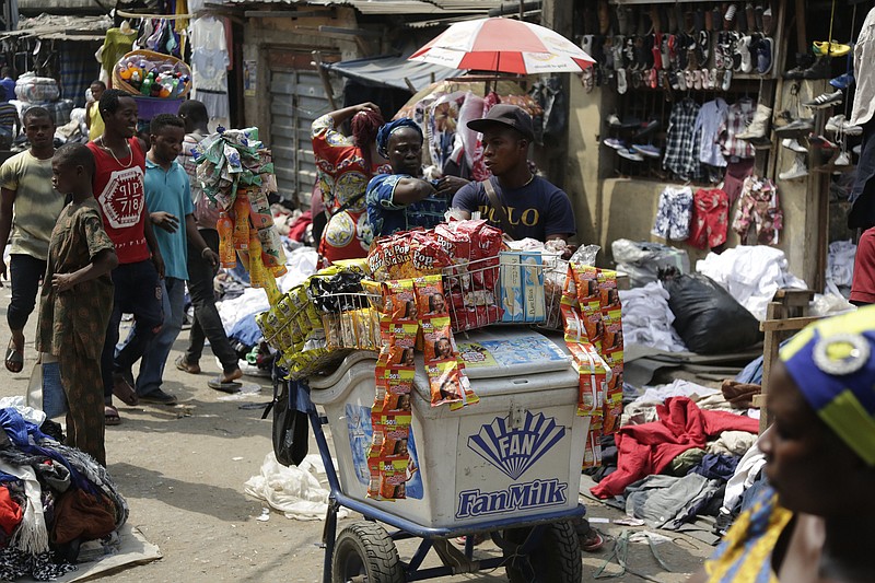 
              Pedestrians shop in a roadside market in Lagos, Nigeria, Friday, Jan. 12, 2018. Africans were shocked on Friday to find President Donald Trump had finally taken an interest in their continent. But it wasn't what people had hoped for. Using vulgar language, Trump on Thursday questioned why the U.S. would accept more immigrants from Haiti and "shithole countries" in Africa rather than places like Norway in rejecting a bipartisan immigration deal. On Friday he denied using that language. (AP Photo/Sunday Alamba)
            