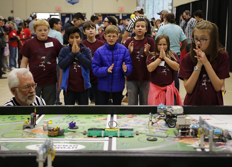 The Aqua Eaglebots react as their robot performs an action at the TVA SuperRegional Robotics FIRST LEGO League Tournament in the Chattanooga State Technical Community College gymnasium on Saturday, Jan. 13, 2018, in Chattanooga, Tenn. Teams from across the region competed in the second round of qualifying competition, and winning teams will compete at Georgia Tech on January 27.