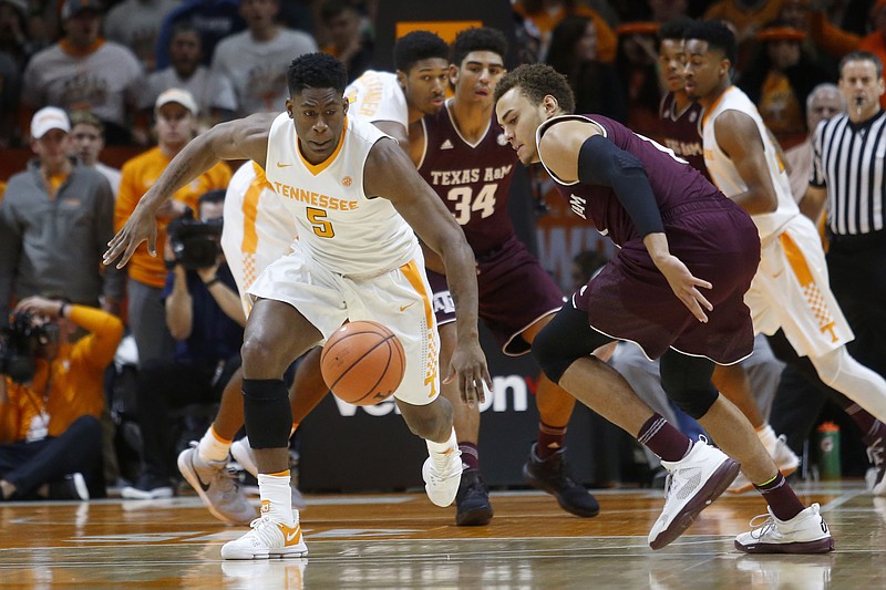 Tennessee forward Admiral Schofield, left, races toward the ball beside Texas A&M forward DJ Hogg, right, during the first half of an NCAA college basketball game Saturday, Jan. 13, 2018, in Knoxville, Tenn. (AP Photo/Crystal LoGiudice)