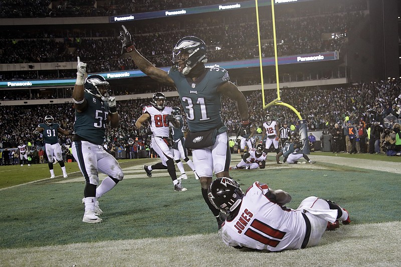 Philadelphia Eagles' Jalen Mills (31) and Brandon Graham (55) celebrate after Atlanta Falcons' Julio Jones (11) cannot catch a fourth down pass during the second half of an NFL divisional playoff football game, Saturday, Jan. 13, 2018, in Philadelphia. Philadelphia won 15-10. (AP Photo/Matt Rourke)