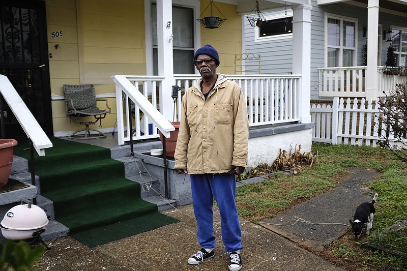 James Woods, who has lived in the Jefferson Heights neighborhood for more than 60 years, poses for a portrait in front of his home with his dog Falco on Friday, Jan. 12, 2018, in Chattanooga, Tenn. Parts of Jefferson Heights, along with locations in Alton Park, Cowart Place, Richmond and the Southside Gardens neighborhoods, have been proposed as EPA Superfund sites after lead contamination was found in the yards of homes.