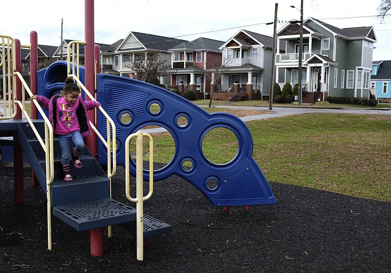 Ma'Kiyah Hodge plays on a playground in the Jefferson Heights neighborhood on Friday, Jan. 12, 2018, in Chattanooga, Tenn. Parts of Jefferson Heights, along with locations in Alton Park, Cowart Place, Richmond and the Southside Gardens neighborhoods, have been proposed as EPA Superfund sites after lead contamination was found in the yards of homes.