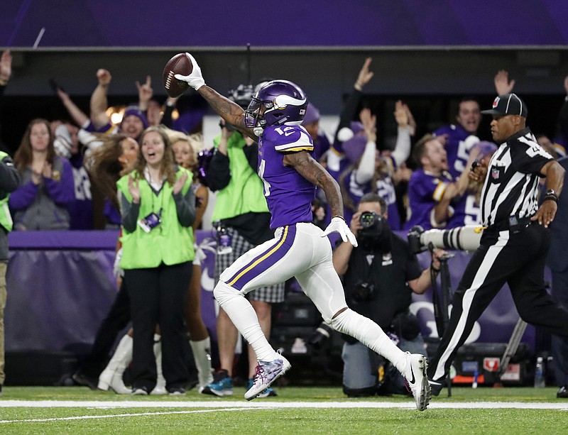 Minnesota Vikings wide receiver Stefon Diggs (14) runs in for a game winning touchdown against the New Orleans Saints during the second half of an NFL divisional football playoff game in Minneapolis, Sunday, Jan. 14, 2018. The Vikings defeated the Saints 29-24. (AP Photo/Jeff Roberson)