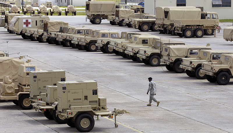 In this 2009 file photo, a soldier walks through the 4th Infantry Brigade Combat Team motor pool at Fort Stewart, Ga.