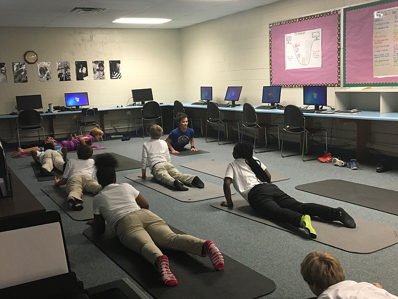 Washington Alternative School students perform the cobra pose during Yoga East Studio's Intro to Yoga course at the school. (Contributed photo)