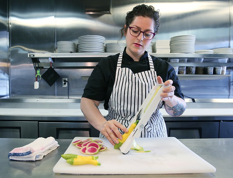 Executive chef Rebecca Barron slices vegetables at St. John's Restaurant, one of the two restaurants she oversees. She also is in charge of St. John's companion restaurant, The Meeting Place.