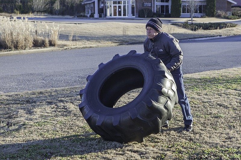 Randy Webb flips a 178-pound tire 150 times.

