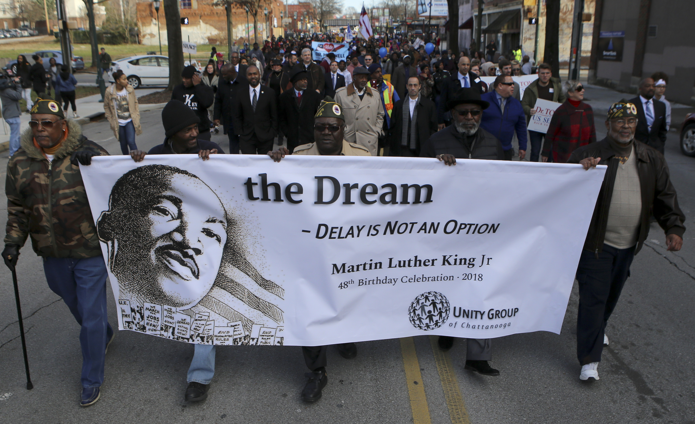 People carry a banner for the Unity Group of Chattanooga during a memorial parade and march along M.L. King Boulevard on Monday, Jan. 15, 2018 in Chattanooga, Tenn. The memorial parade and march was part of the Unity Group of Chattanooga's 48th annual Martin Luther King Jr. Week celebration, which began on Jan. 8th and ended on Martin Luther King Jr. Day.