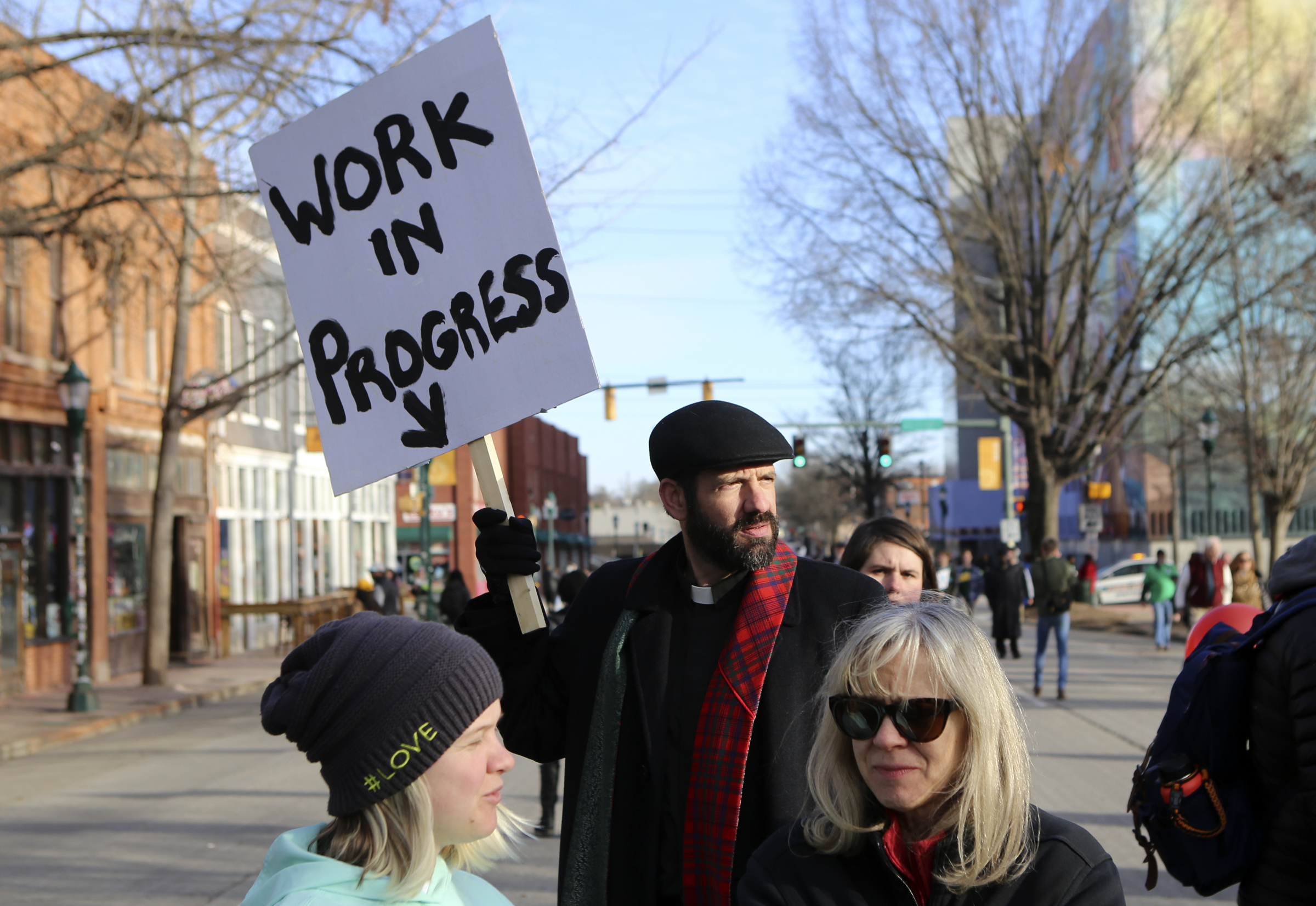 Clay Thomas holds up a sign reading