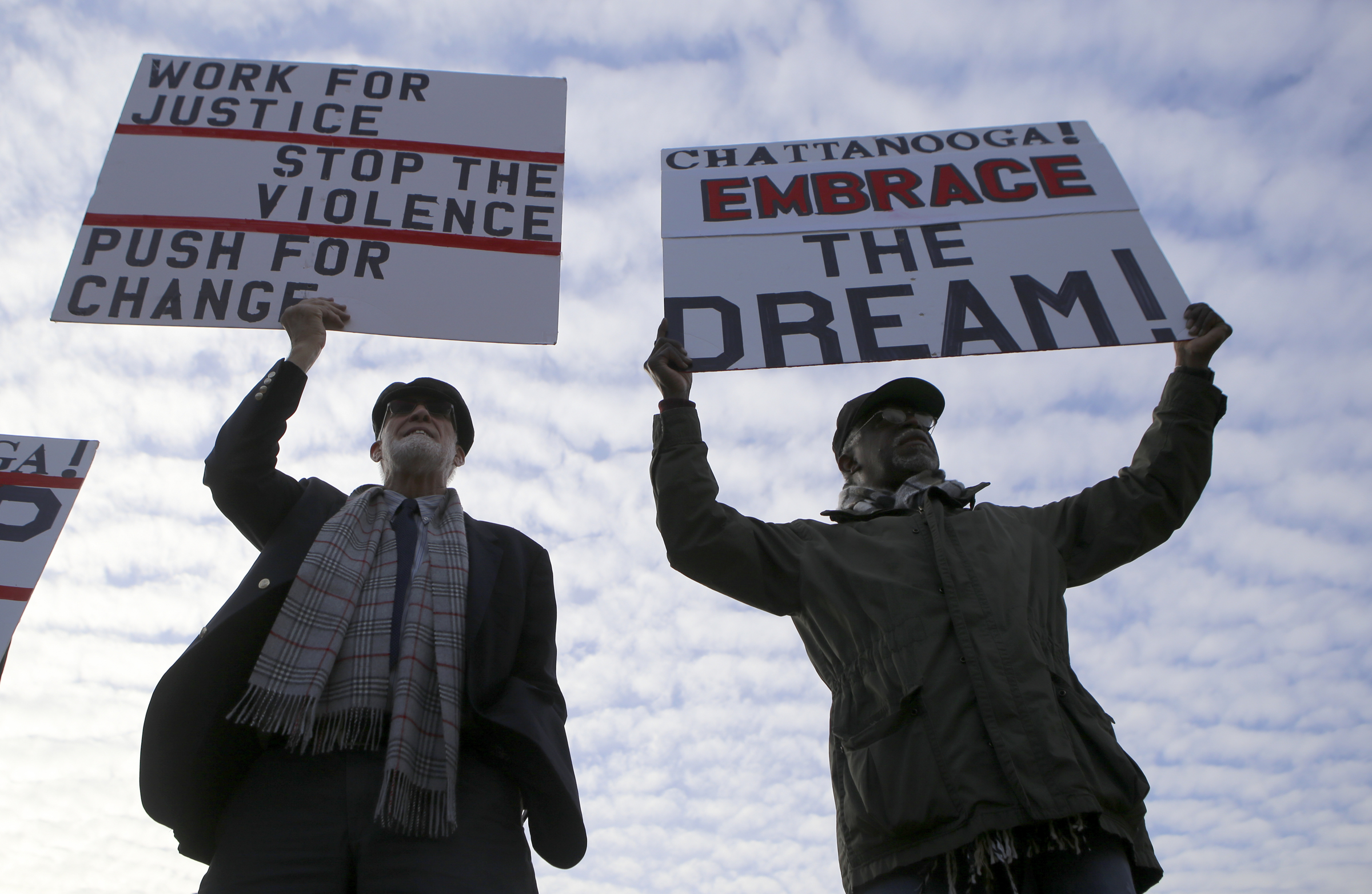 Franklin McCallie, left, and Cary Garrett hold up signs in front of the Bessie Smith Cultural Center after a memorial parade and march along M.L. King Boulevard on Monday, Jan. 15, 2018 in Chattanooga, Tenn. The memorial parade and march was part of the Unity Group of Chattanooga's 48th annual Martin Luther King Jr. Week celebration, which began on Jan. 8th and ended on Martin Luther King Jr. Day.